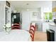 Kitchen features white cabinetry, stainless appliances, eating area, and a sliding door to laundry room at 5115 Cascade Palmetto Hwy, Fairburn, GA 30213