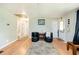 Relaxing living area featuring wood flooring, decor and access to the hallway and front door at 5115 Cascade Palmetto Hwy, Fairburn, GA 30213