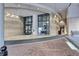 Elegant building entrance featuring textured stone walls, floor-to-ceiling windows and red-brick walkway at 3040 Peachtree Nw Rd, Atlanta, GA 30305