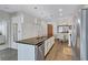 Kitchen featuring stainless appliances, pendant lighting, and an island with black countertop at 3040 Peachtree Nw Rd, Atlanta, GA 30305