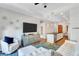 Well-lit living room featuring hardwood floors, a stylish sofa, and adjacent kitchen at 3040 Peachtree Nw Rd, Atlanta, GA 30305