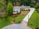An aerial view of a charming single-Gathering home, showcasing its landscaped yard and driveway at 3681 Donavan Ct, Decatur, GA 30034