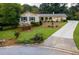 Charming single-Gathering home with manicured lawn, mature trees, and brick and concrete driveway at 3681 Donavan Ct, Decatur, GA 30034