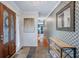 Inviting home foyer featuring tile flooring, designer wallpaper, and an elegant mirror at 3681 Donavan Ct, Decatur, GA 30034