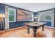 Spacious game room offers natural light, hardwood floors, and a full sized pool table at 3681 Donavan Ct, Decatur, GA 30034