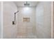 Contemporary bathroom featuring neutral colored tile, pebble floor, rainfall shower head, and built-in niche at 3681 Donavan Ct, Decatur, GA 30034