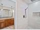 Modern walk-in shower boasts neutral colored tile, a rainfall shower head, and built-in niche at 3681 Donavan Ct, Decatur, GA 30034