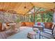 Cozy screened-in sunroom with wood paneling, comfortable seating, and natural light at 3681 Donavan Ct, Decatur, GA 30034
