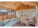 Comfortable screened-in sunroom featuring wood walls, a ceiling fan, and cushioned seating at 3681 Donavan Ct, Decatur, GA 30034