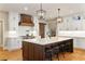 Well-appointed kitchen featuring a large center island with seating and custom cabinetry at 2063 Windermere Xing, Cumming, GA 30041