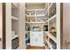 Walk-in pantry with custom shelving, providing ample storage space for kitchen essentials at 2063 Windermere Xing, Cumming, GA 30041