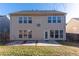 View of the rear exterior of the home showcasing its spacious backyard at 2496 Gristhaven Ln, Buford, GA 30519