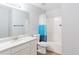 The bathroom includes a white shower and toilet, a granite counter vanity, and wood flooring, offering functionality at 2496 Gristhaven Ln, Buford, GA 30519