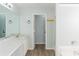 Spacious bathroom with long vanity and double sinks, plus a shower and tub at 2496 Gristhaven Ln, Buford, GA 30519