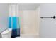 Bright bathroom features a tub and shower with a modern blue-striped curtain at 2496 Gristhaven Ln, Buford, GA 30519