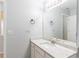 Light and airy bathroom featuring granite countertop and white cabinets at 2496 Gristhaven Ln, Buford, GA 30519
