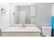 This bathroom features a large mirror above a granite-style countertop with a modern faucet and white cabinets at 2496 Gristhaven Ln, Buford, GA 30519