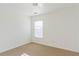 A naturally lit bedroom with neutral carpet features a window and a ceiling fan, offering a cozy and comfortable feel at 2496 Gristhaven Ln, Buford, GA 30519