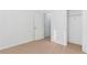 A vacant bedroom showcases neutral carpet and white walls, leading to an attached closet and additional living spaces at 2496 Gristhaven Ln, Buford, GA 30519