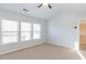 Bright bedroom with carpet, ceiling fan, and ample natural light from large windows at 2496 Gristhaven Ln, Buford, GA 30519