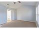 Bright bedroom with neutral carpet, ceiling fan, and ensuite bathroom at 2496 Gristhaven Ln, Buford, GA 30519