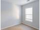 The bedroom is well-lit, featuring neutral carpet, a window, and bright white walls, creating a clean and airy space at 2496 Gristhaven Ln, Buford, GA 30519