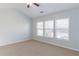 Bright bedroom features neutral carpet, blue paint, and large windows offering ample natural light at 2496 Gristhaven Ln, Buford, GA 30519