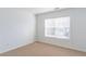 Carpeted bedroom featuring a large window and neutral wall color at 2496 Gristhaven Ln, Buford, GA 30519