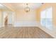 Dining room featuring wood floors, decorative trim and a stylish chandelier at 2496 Gristhaven Ln, Buford, GA 30519