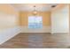 Bright dining room featuring wood-look flooring, stylish chandelier, and large window at 2496 Gristhaven Ln, Buford, GA 30519