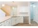 Bright kitchen features white cabinets, granite countertops, stainless steel dishwasher, and pendant lighting at 2496 Gristhaven Ln, Buford, GA 30519
