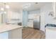 Spacious kitchen with granite countertops, stainless steel appliances, and wood flooring at 2496 Gristhaven Ln, Buford, GA 30519