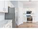 A modern kitchen boasts stainless appliances and granite countertops at 2496 Gristhaven Ln, Buford, GA 30519