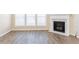 Inviting living room boasting wood-look floors and a modern fireplace at 2496 Gristhaven Ln, Buford, GA 30519