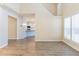 Spacious living room featuring wood-look floors with staircase and kitchen views at 2496 Gristhaven Ln, Buford, GA 30519