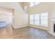 Sun-filled living room with wood-look floors and fireplace at 2496 Gristhaven Ln, Buford, GA 30519