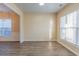 Neutral living room featuring wood floors and abundant natural light through windows at 2496 Gristhaven Ln, Buford, GA 30519