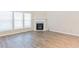 Cozy living room featuring wood-look floors and fireplace at 2496 Gristhaven Ln, Buford, GA 30519