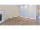 Bright living room offers wood-look floors and easy access to other rooms at 2496 Gristhaven Ln, Buford, GA 30519
