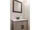 Elegant bathroom featuring a vanity with bronze fixtures, a decorative mirror and neutral walls at 1126 Village Se Ct, Atlanta, GA 30316