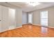 Bedroom featuring hardwood floors, natural light, closet, and neutral colored walls at 1126 Village Se Ct, Atlanta, GA 30316