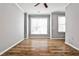 Bright living room with hardwood flooring, neutral paint, white crown molding, ceiling fan and lots of natural light at 1126 Village Se Ct, Atlanta, GA 30316