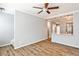 Open-concept living room with hardwood floors, ceiling fan, and an opening to the kitchen with stainless steel appliances at 1126 Village Se Ct, Atlanta, GA 30316
