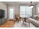 Inviting living room with hardwood floors, large windows, and stylish modern furniture at 1126 Village Se Ct, Atlanta, GA 30316