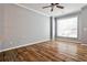 Bright living room with hardwood flooring, neutral paint, white crown molding, ceiling fan and lots of natural light at 1126 Village Se Ct, Atlanta, GA 30316