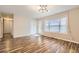 Spacious living room featuring hardwood floors, a large window and access to the hallway at 2248 Greenway Drive, Decatur, GA 30035