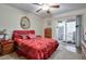 Bedroom featuring a red comforter, ceiling fan, and access to an outdoor patio at 2937 Torreya Way, Marietta, GA 30067