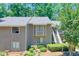 Exterior view of a two-story condo featuring a gray facade, multiple windows and mature trees at 2937 Torreya Way, Marietta, GA 30067