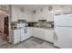 Charming kitchen with white cabinets, appliances, and a decorative backsplash design at 2937 Torreya Way, Marietta, GA 30067