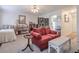 Cozy living room featuring neutral carpet, red sofa, and decorative screen at 2937 Torreya Way, Marietta, GA 30067